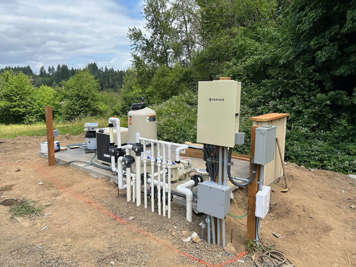 Outdoor pool equipment pad with a control panel, disconnects, pumps and neatly run conduit